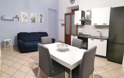 eine Küche und ein Wohnzimmer mit einem weißen Tisch und Stühlen in der Unterkunft Civico56 in Patti