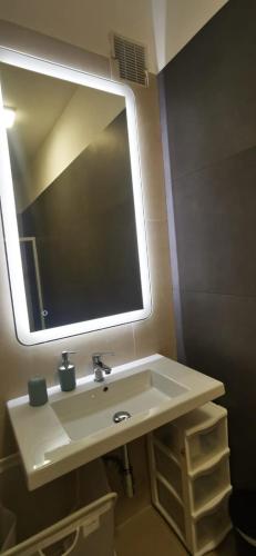 a bathroom sink with a large mirror above it at CORFÙ 19 Bed & Breakfast in Schiavonea