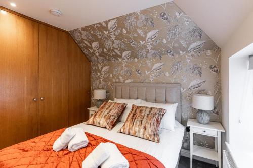 a bedroom with a bed with two towels on it at New Apartment in Guildford in Guildford