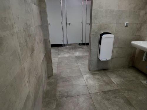 a bathroom with a urinal and a sink in a stall at Kemp Koruna in Zlatá Koruna