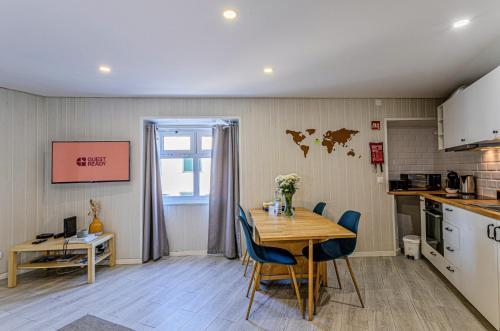 a kitchen and dining room with a table and chairs at GuestReady - Beachside house with ocean view in Ponta Delgada