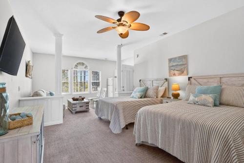 a bedroom with two beds and a ceiling fan at 2BR Condo with Golf Views Near Sunset Beach in Sunset Beach
