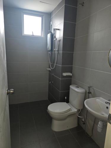 a bathroom with a toilet and a shower and a sink at Aliffheight in Johor Bahru