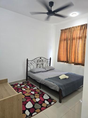 a bedroom with a bed and a ceiling fan at Aliffheight in Johor Bahru