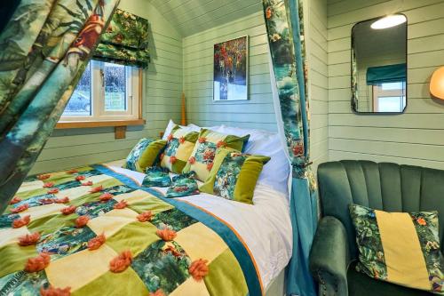 a bedroom with a bed with a comforter and pillows at Host & Stay - Curlews Rest in Longridge