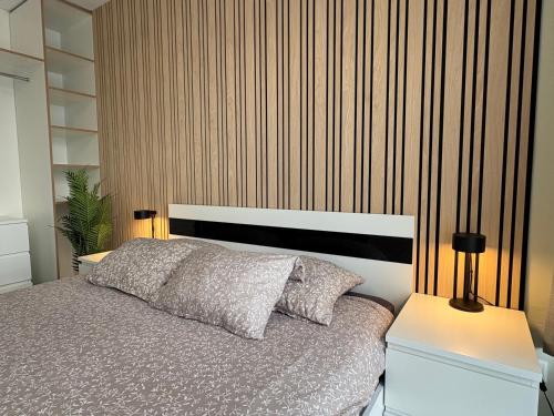 a bedroom with a bed and two lamps on tables at Weekend apartment 3 in Sigulda