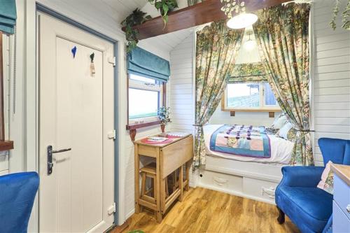 a small room with a bed and a desk and a window at Host & Stay - Swallows Nest in Longridge