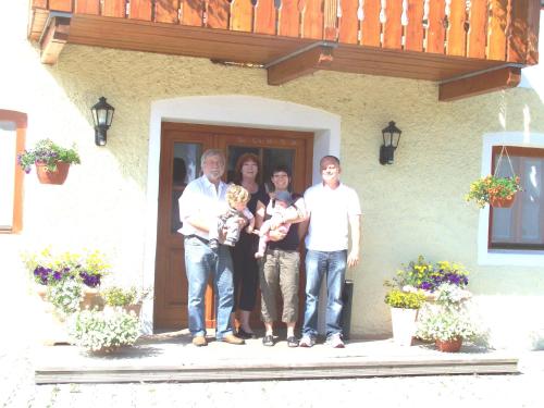 a group of people standing in front of a house at Pension Poschmühle in Traunreut