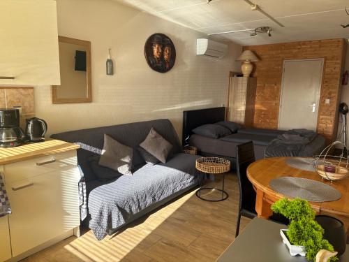a living room with a couch and a table at La Casa aan Zee in Ellemeet