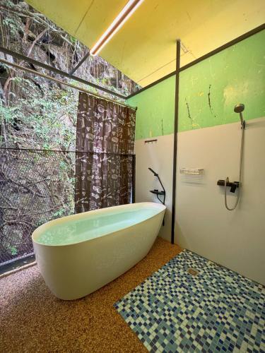 a bath tub in a bathroom with a window at Xscape Tambun in Ipoh