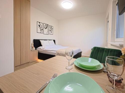 a dining room with a table and a bed at Studio Ariel in Veľký Meder
