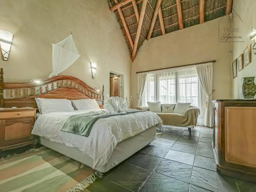 a bedroom with a large bed and a television at Cherry Creek at Zebula in Warmbaths