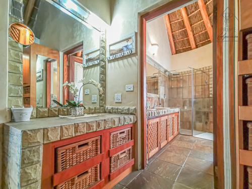 a bathroom with a sink and a shower at Cherry Creek at Zebula in Warmbaths