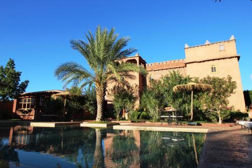 a resort with a swimming pool in front of a building at La Kasbah d'Ouzoud in Ouzoud