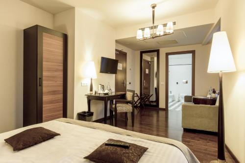 a bedroom with a bed and a living room at Europa Royale Bucharest in Bucharest