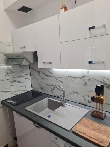a kitchen with a sink and a counter top at Zakątek Spokoju in Toruń
