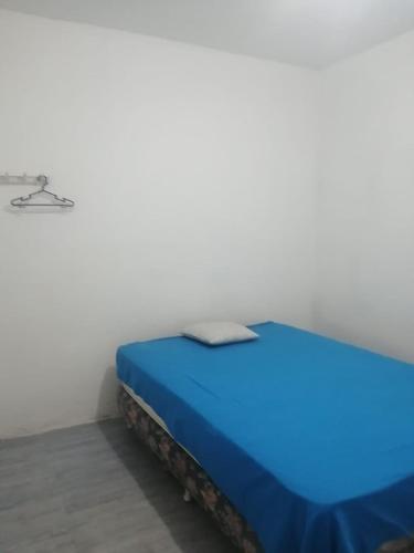 a bed in a room with a blue bed at Punta hermosa casa playa in Punta Hermosa