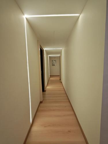 a hallway with white walls and a wooden floor at The Loft hotel 68 in Butterworth