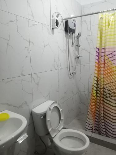 a bathroom with a toilet and a sink and a shower at Punta hermosa casa playa in Punta Hermosa