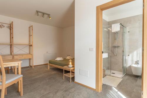 a bathroom with a bed and a shower and a sink at Nest Family, Bedollo Ospitar in Bedollo