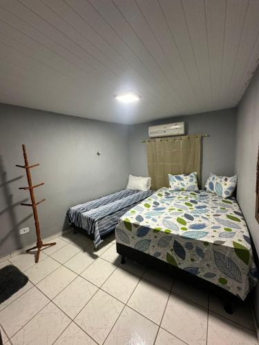 a bedroom with two beds in a room at A queridinha do Orange in Itamaracá