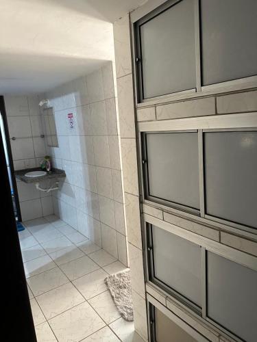 a bathroom with a shower with a toilet and a sink at A queridinha do Orange in Itamaracá