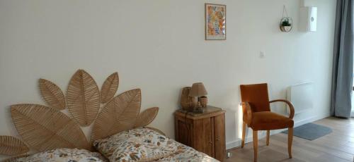 a room with a bed and a chair and a table at Studio85 in La Gaubretière