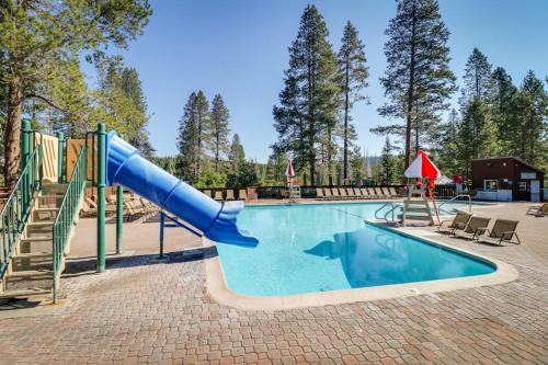 a slide in a swimming pool with a playground at Tranquil cabin near ski slopes & trails with wraparound deck & pool table in Truckee