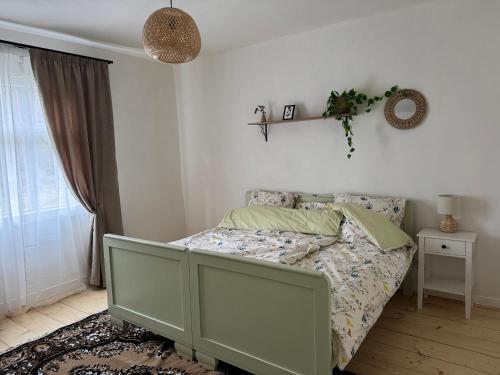 a bedroom with a bed and a window at zelena khata in Sopot