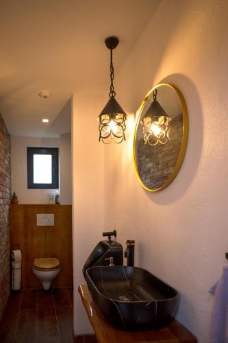 a bathroom with a black sink and a mirror at Kuća za odmor Kiljer - priroda, pogled i slavonski ugođaj in Grgurevići