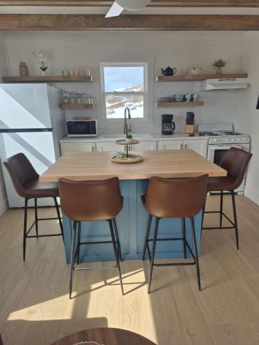 eine Küche mit einem Holztisch und Stühlen in der Unterkunft Durrell's Nook in Twillingate