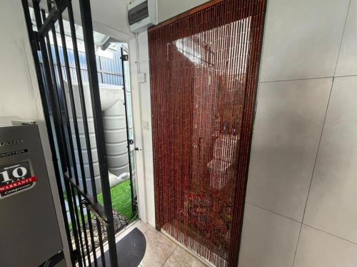 a door with a metal gate in a building at PRIBO's in Flic-en-Flac