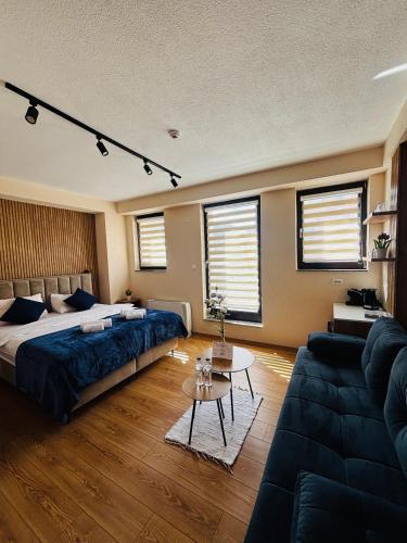 a bedroom with a bed and a couch at TASY Guest House - Luxury Rooms in the Heart od SHIROK SOKAK in Bitola