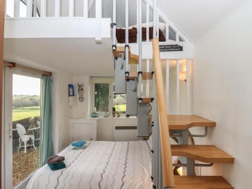 a bedroom with a bunk bed in a tiny house at The Old Telephone Exchange in Exeter