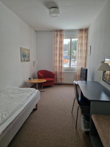 a hotel room with a bed and a desk at Dorotea Logi B&B in Dorotea