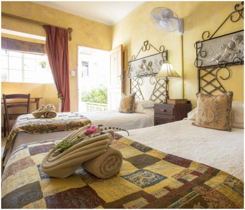 a hotel room with two beds and a window at De Ark Guest House in Lydenburg