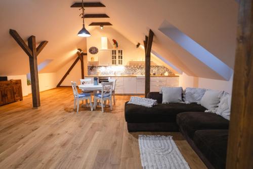 a living room with a couch and a table at Farma Mlýn Drásov in Drásov
