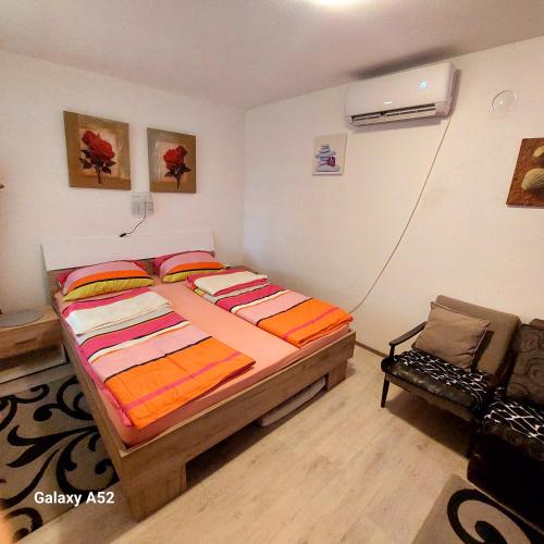 a bedroom with a bed and a chair in it at Green in Negotin