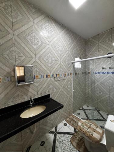 a bathroom with a sink and a toilet at Casa em Jacumã in Conde