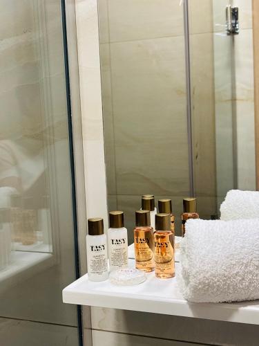 a group of four bottles of essential oils on a bathroom counter at TASY Guest House - Luxury Rooms in the Heart od SHIROK SOKAK in Bitola