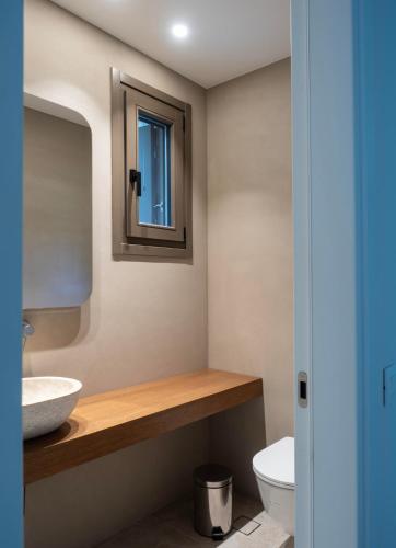 a bathroom with a sink and a mirror at Fenia's Paradise Villa in Houlakia