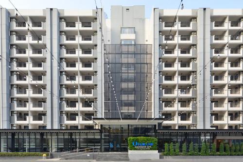 a large white apartment building with a sign in front of it at O2 Grand Suvarnabhumi Airport - Free Scheduled Shuttle from Hotel to Suvarnabhumi Airport in Bang Phli