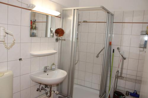 a white bathroom with a sink and a shower at Ferienwohnung an der Ostsee E311 in Brasilien