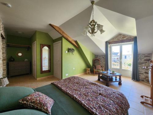 a bedroom with green walls and a large bed at La Source Du Bonheur Chambres et Table d'Hôtes in Rieupeyroux