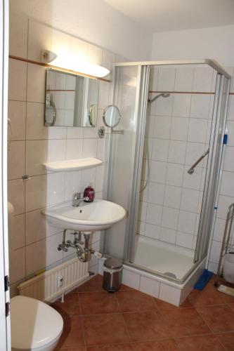 a bathroom with a sink and a shower and a toilet at Fereinwohnung an der Ostsee E312 in Schönberg