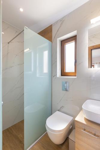 a bathroom with a toilet and a sink at Azzure Studio in Kokkari