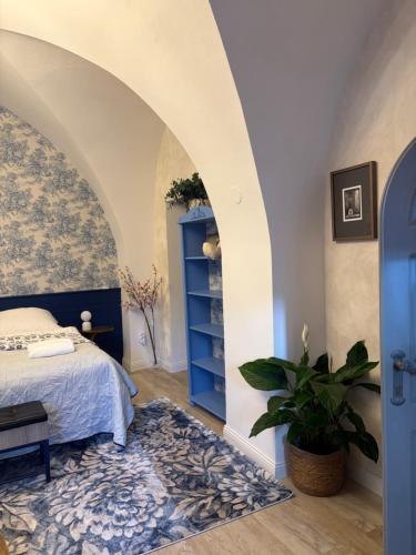 a bedroom with a bed and a blue cabinet at Apartmán No 244 in Tábor