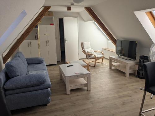 a living room with a couch and a tv at Ferienwohnung in Schkölen in Schkölen