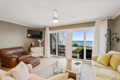 a living room with a couch and a table at Blue Tide #8A in Seacrest