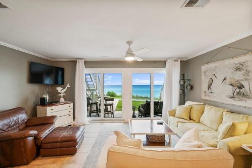 a living room with a couch and a table at Blue Tide #8A in Seacrest